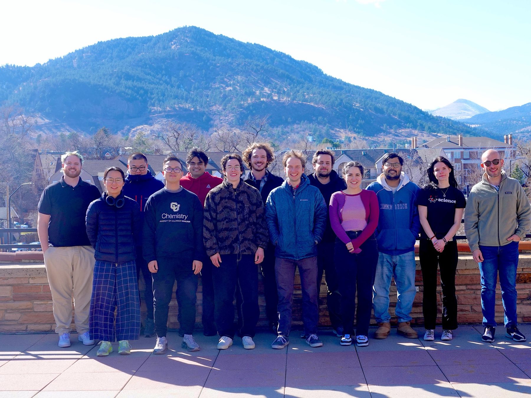 The Montoya-Castillo Group standing together outdoors with the Boulder foothills behind them