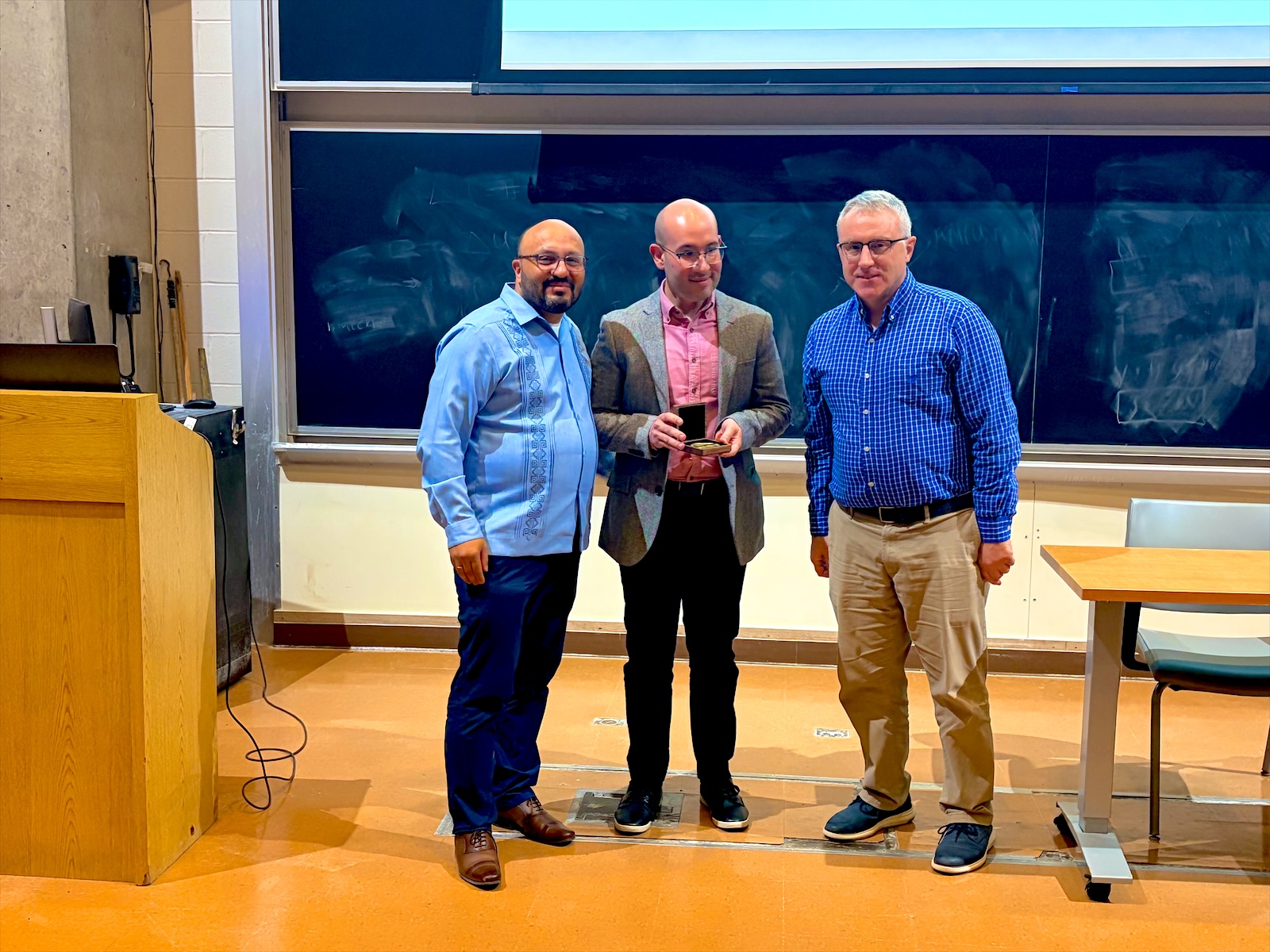 Andrés receiving the Magomedov-Shcherbinina medal with Ignacio Franco and Todd Krauss